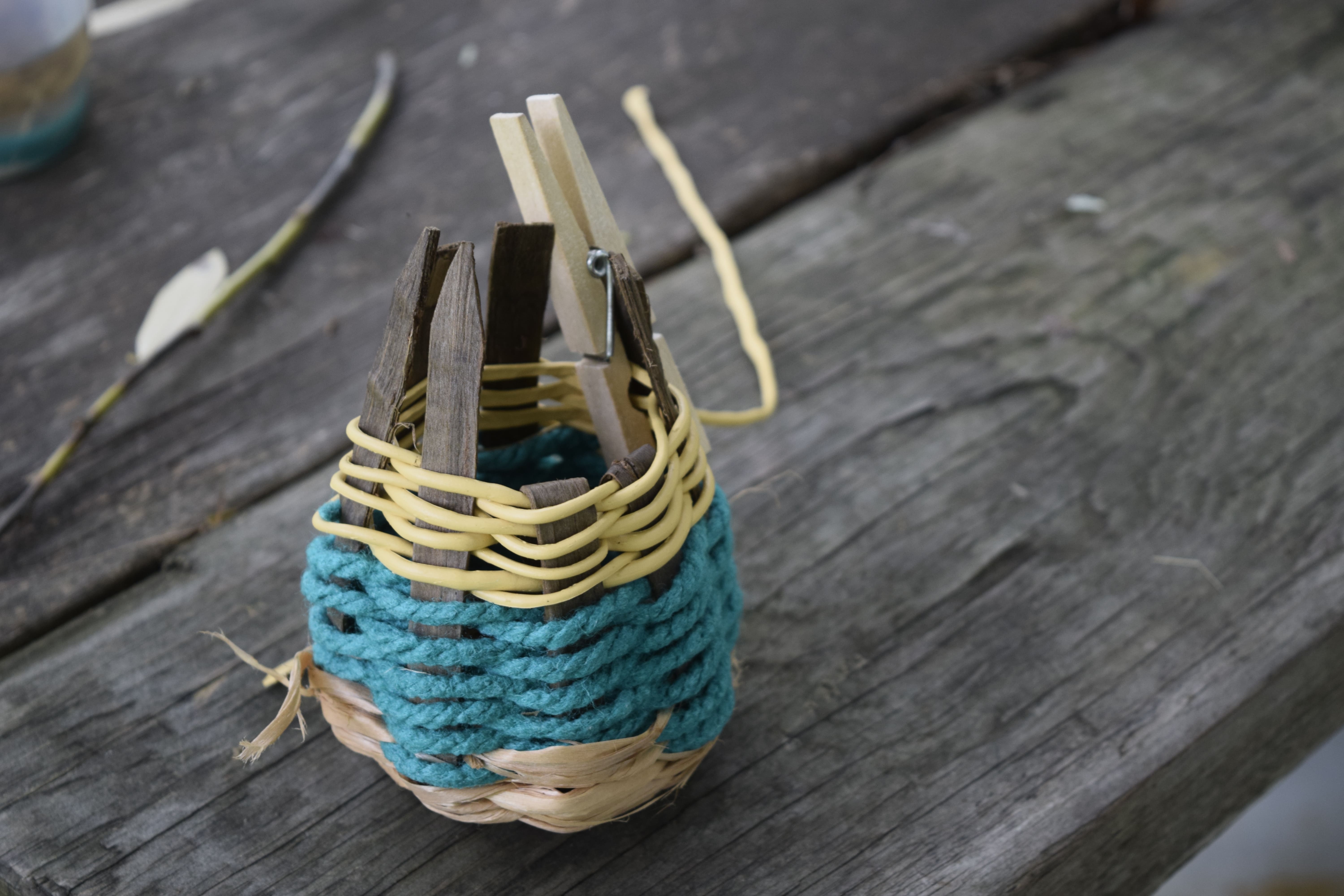a twined basket using black walnut, basswood, and alternative materials