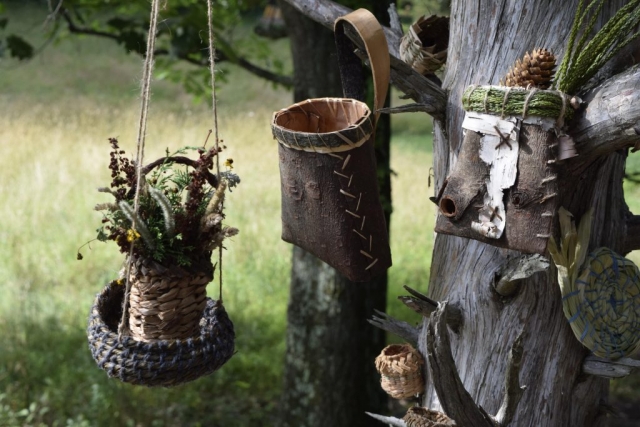 a tree covered in beautiful baskets, coiled, twined, and folded pine bark